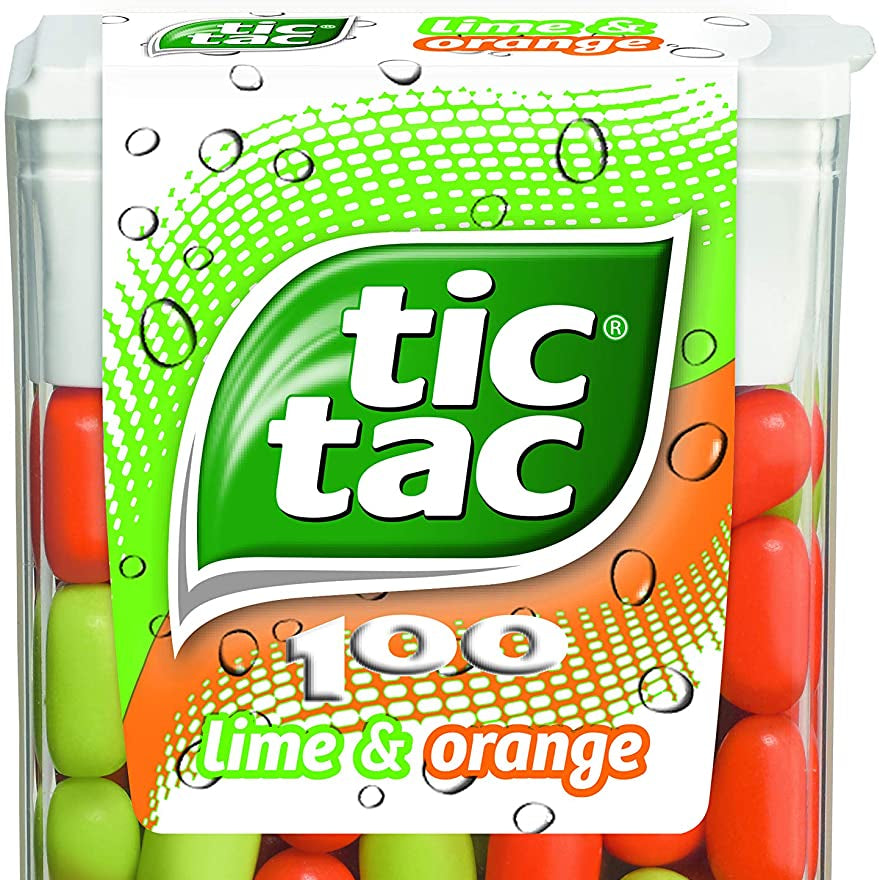 A clear plastic tube packaging containing Tic Tac lime and orange candies.