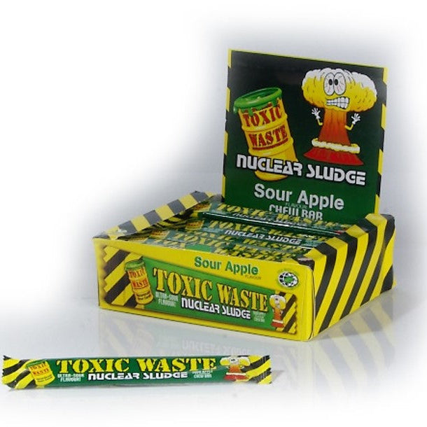 A box of Toxic Waste Apple Nuclear Sludge Bars with individual packaging shown in front. The box has a green and yellow color scheme with a cartoon apple and sludge character.
