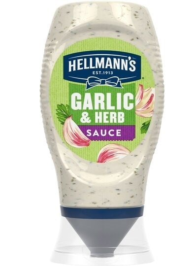 A bottle of Hellmann's Garlic & Herb Sauce, with visible pieces of garlic and herbs integrated throughout the sauce.