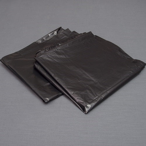 Two black garbage bags on a gray background.