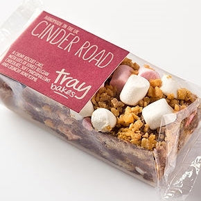 Packaged tray of Traybakes wrapped cinder road biscuits with visible marshmallows and honeycomb pieces.