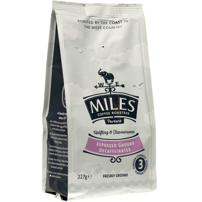 A package of MILES decaf ground coffee, 227g, with branding and product information displayed on the front.