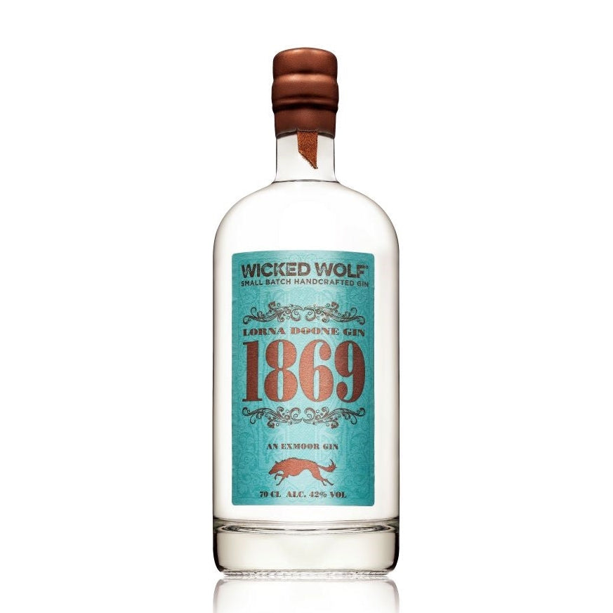A bottle of WICKED WOLF '1869' GIN with a label that has a vintage look, predominantly white with blue and red accents, and a wooden cap.