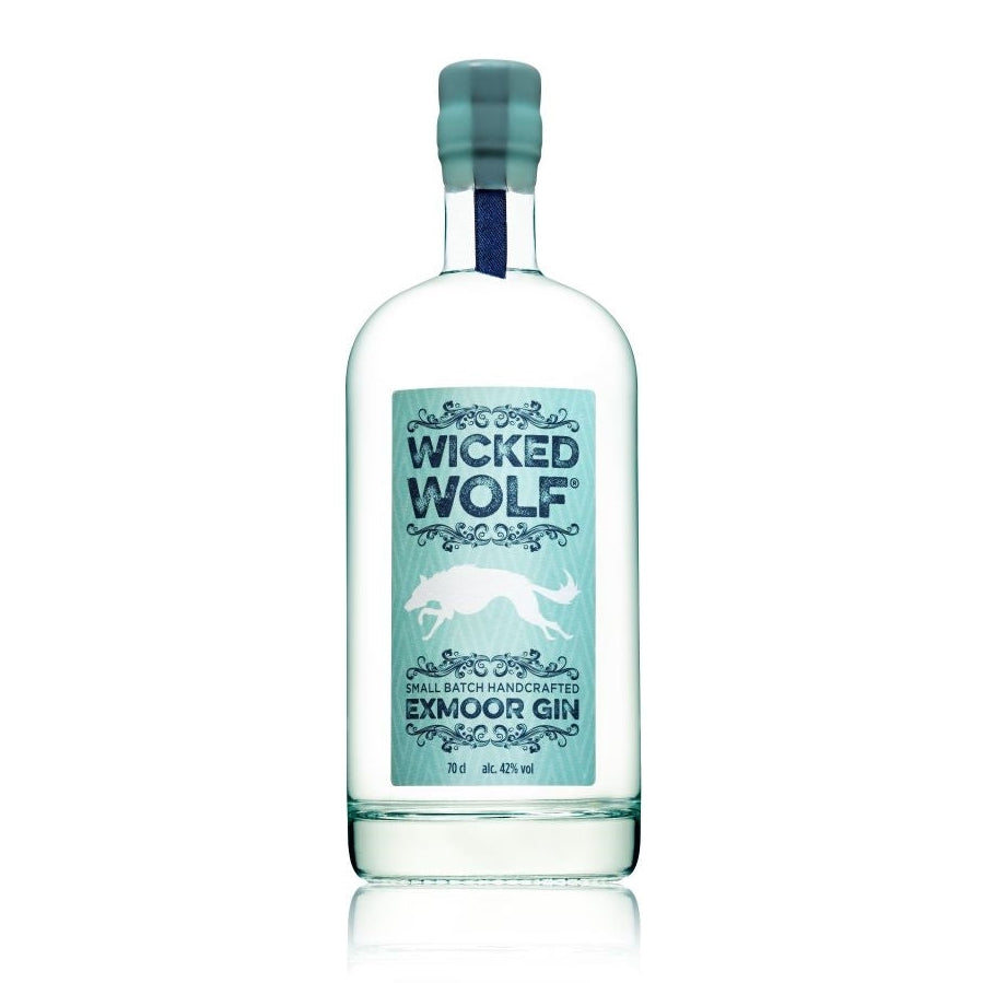 This image features a sleek bottle of "WICKED WOLF GIN 70CL X 6," part of a six-bottle pack. The gin bottle is clear, allowing the clean, light-colored liquid inside to be visible, and it's adorned with a stylish, rustic label that reads "WICKED WOLF EXMOOR GIN" in a prominent, bold font.