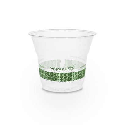 A clear plastic disposable cup with a green Vegware branding around the lower part.