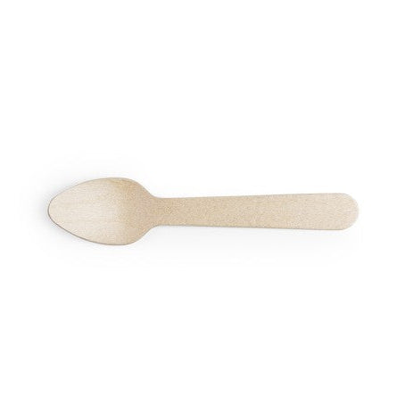 A single wooden tea spoon on a plain background.