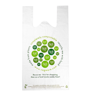 A white compostable carrier bag with green circular designs and text indicating the product is eco-friendly.