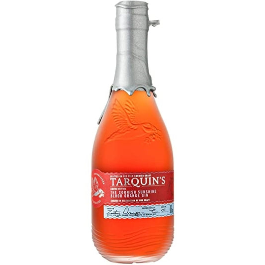 A bottle of Tarquin's Blood Orange Gin with a clear amber liquid visible through the transparent glass and a red label.