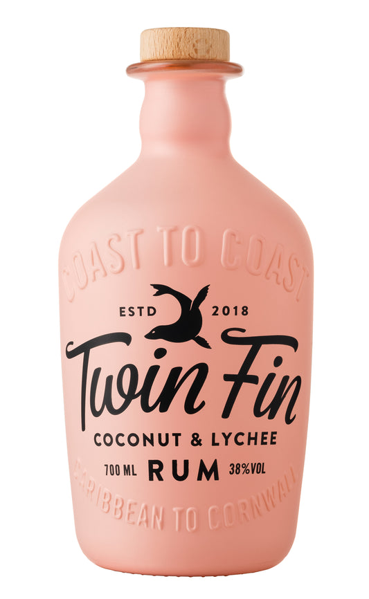 This image features a bottle of Twin Fin Coconut & Lychee Rum, presented in a striking pink hue. The bottle design is sleek and modern, with a capacity of 70cl, and prominently displays the Twin Fin logo along with the flavor profile of coconut and lychee.