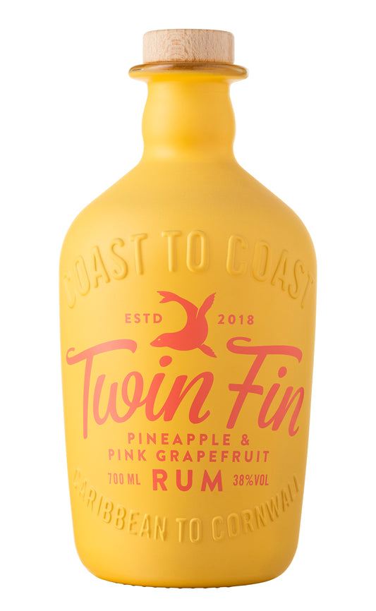This image features a bottle of "Twin Fin" rum, which is flavored with pineapple and pink grapefruit as indicated by the product title. The rum bottle is distinctive with its bright yellow color and bold, orange-toned label that includes the Twin Fin logo and the flavor descriptions.