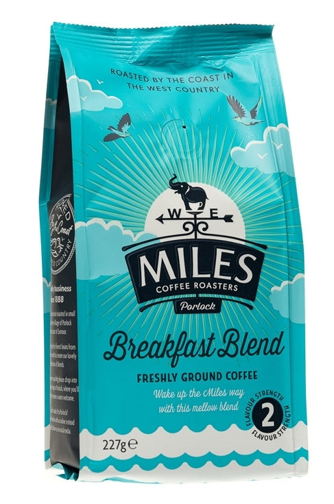 A pack of Miles Breakfast Blend coffee, 227g size, with a blue color theme and branding that includes a graphic of a sheep and a cow, indicating it is roasted in Porthcawl, Wales.