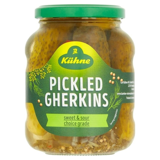 A jar of KUHNE pickled gherkins, with visible pickled cucumbers, labeled as sweet & sour choice grade.