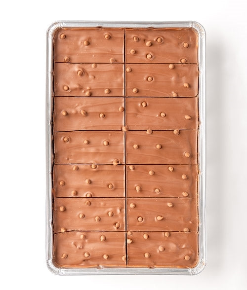 A tray of milk chocolate biscuit tiffin with sultanas and glace cherries.