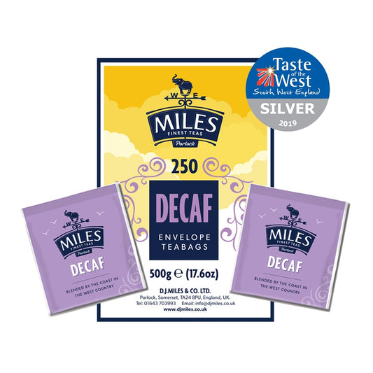 Packaging for Miles decaffeinated tea bags. The package has a yellow and purple design, with the Miles logo and a cat illustration.