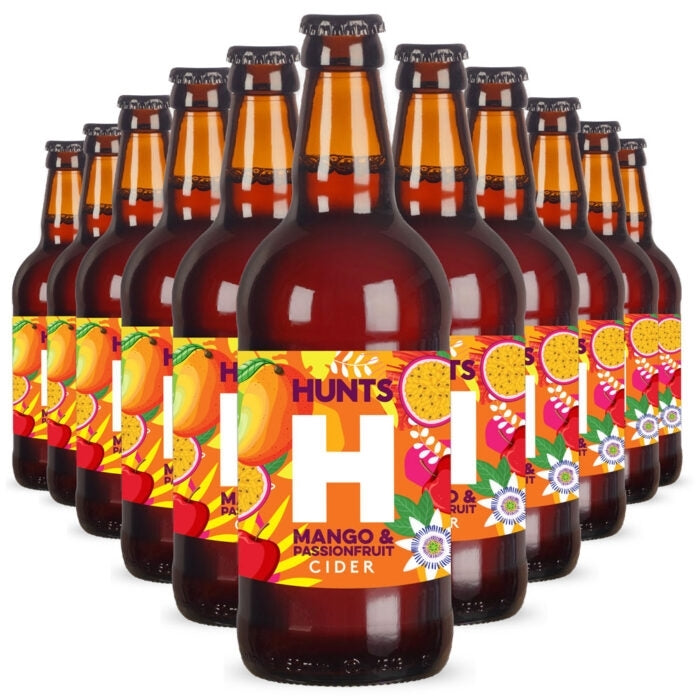 A group of Hunt's Mango & Passionfruit Cider bottles arranged in a fan shape on a white background. The amber glass bottles feature colorful labels with illustrations of mangoes and passionfruit.