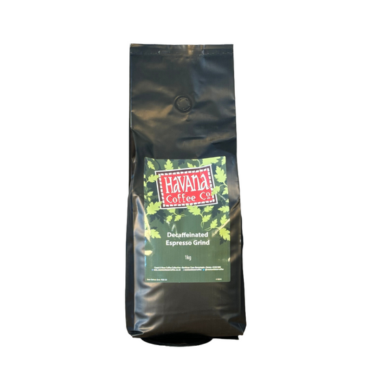 A black bag of Havana Decaf Coffee 1 kg Espresso Ground with the brand logo and a picture of green coffee beans on the front.
