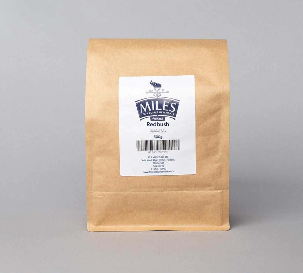 A brown paper bag of Redbush loose leaf tea, 500g, with a label displaying the brand and product name.