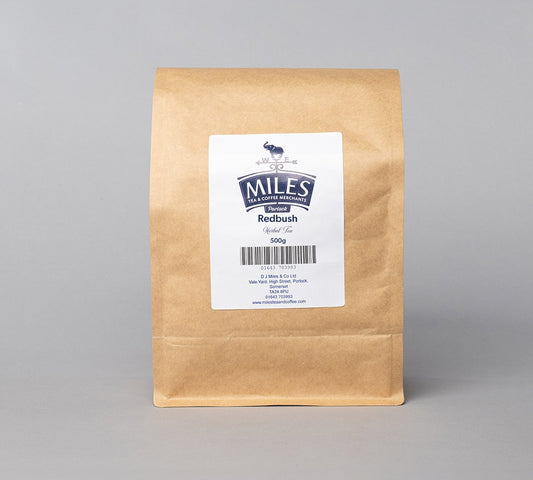 A brown paper bag of Redbush loose leaf tea, 500g, with a label displaying the brand and product name.
