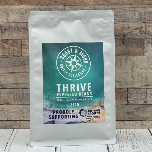 Coast & Moor Coffee Collective Thrive Espresso Beans package on a wooden background