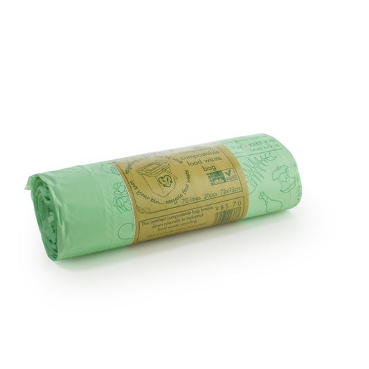 A rolled-up compostable sack, presumably made of green material, with branding and product information printed on a label.
